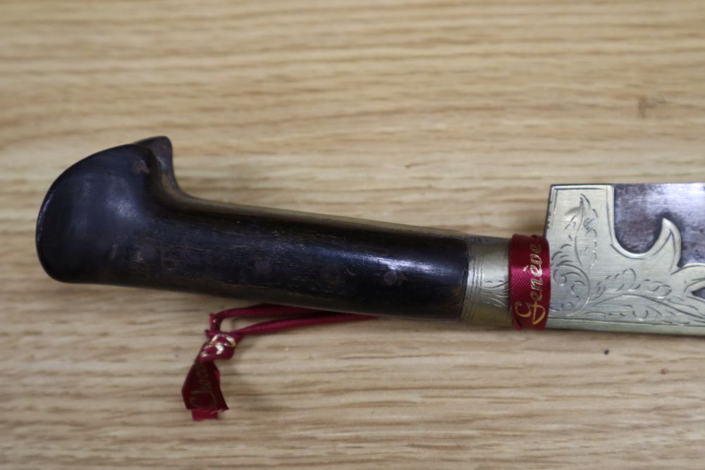 A 19th century Javanese kris, with 14 inch blade, two other edged weapons and a ceremonial head-dress